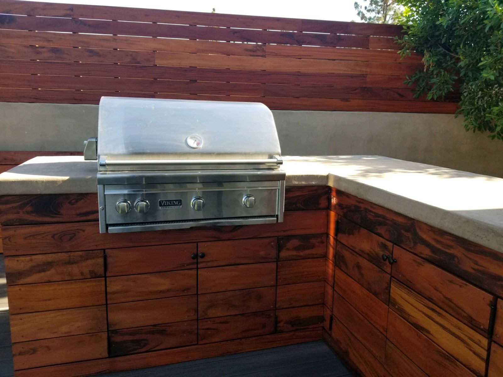 modern barbecue grill set in a wood and stone counter