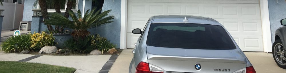 driveway with two cars parked at garage door