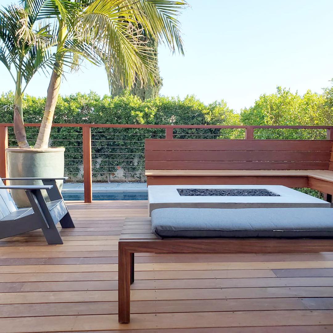 comfortable wooden deck project beneath blue sky and palm trees