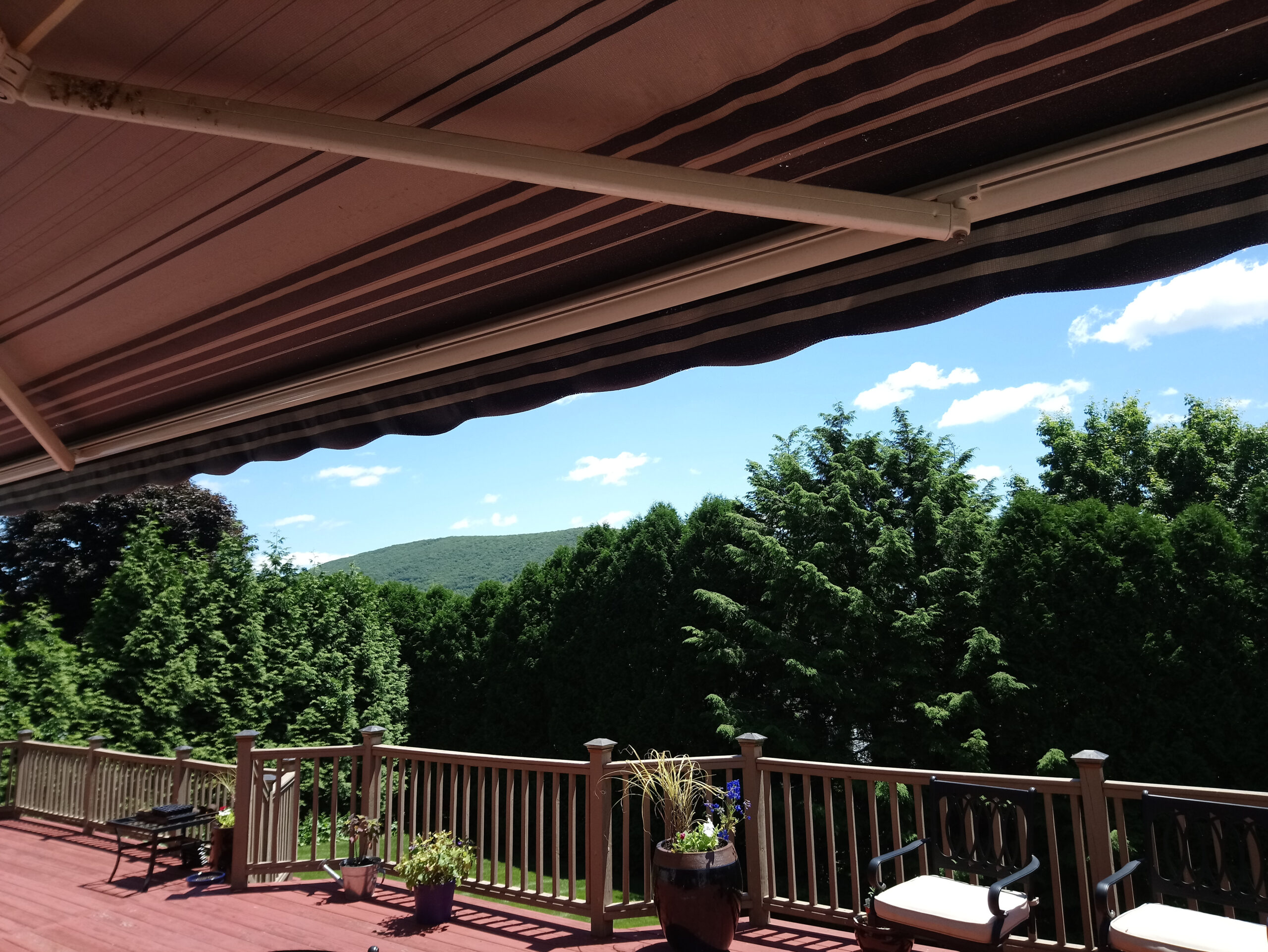 view of trees and hills fro beneath an awning