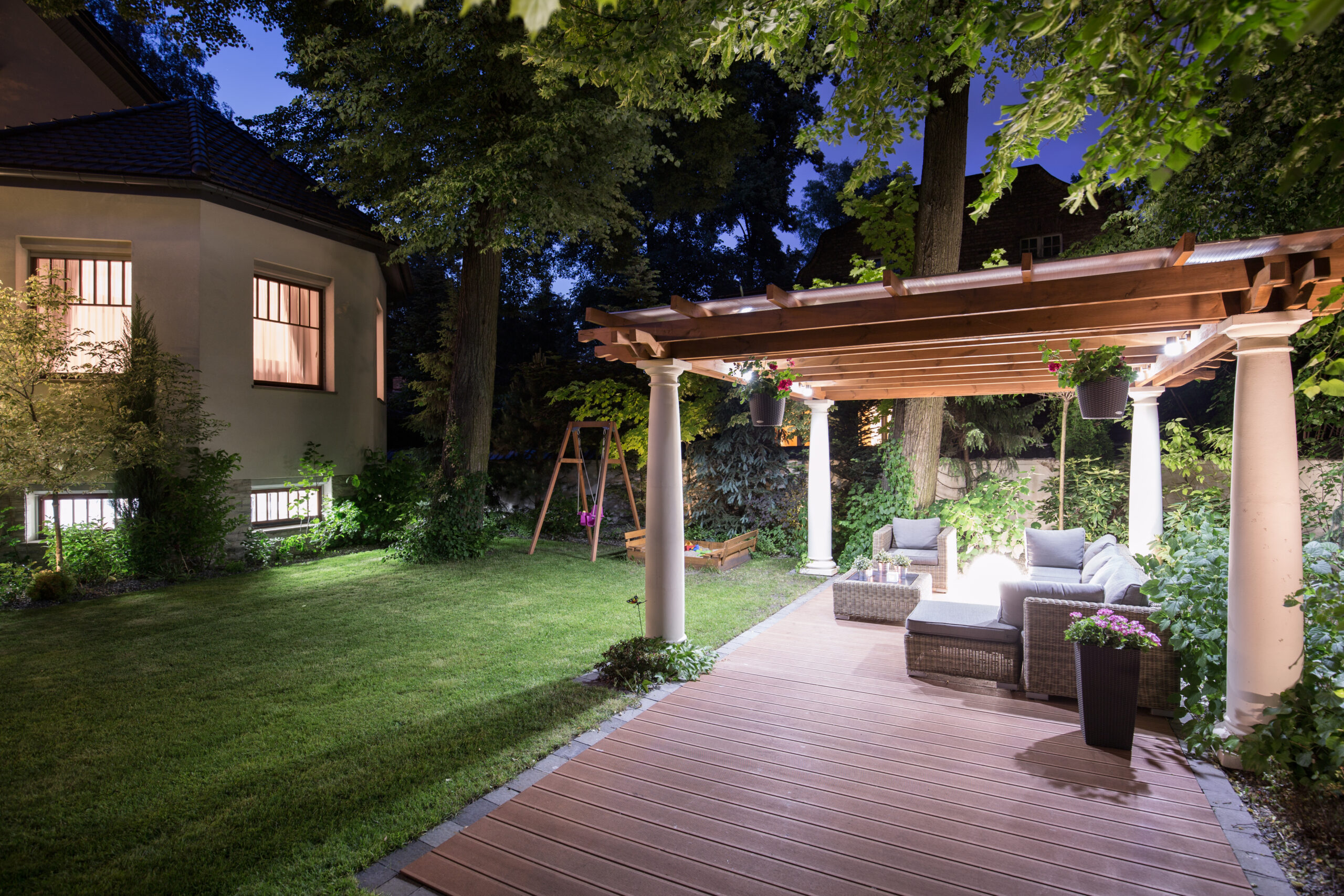 lighted backyard seating area at dusk