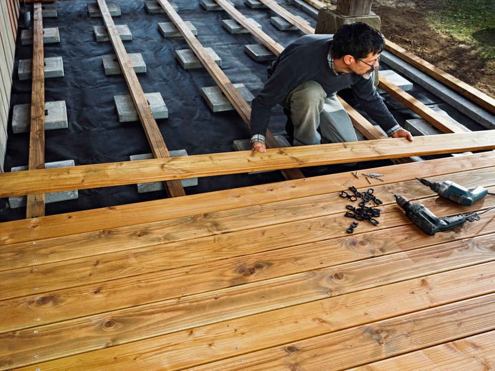man installing timbertech deck planks