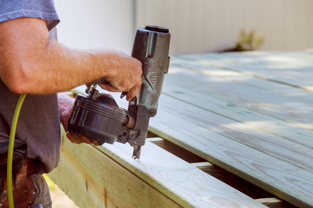 using a nail gun to install deck planks