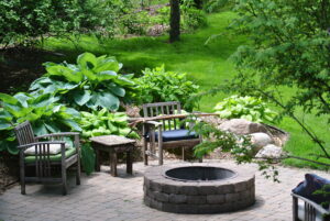 A fire pit in a beautiful, lush backyard