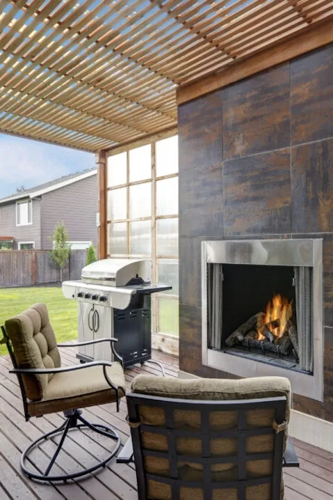 Outdoor fireplace by MG Construction & Decks